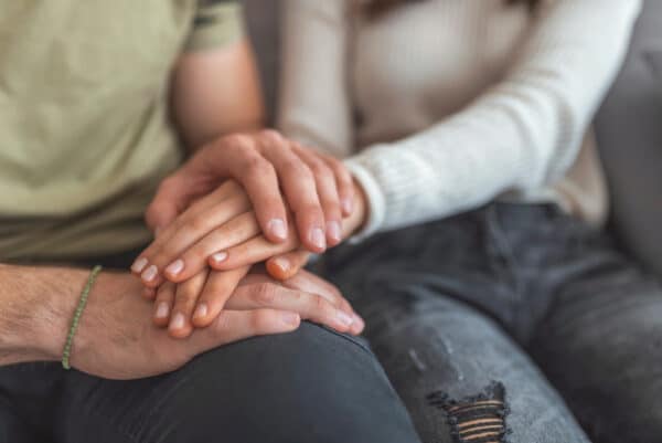 Couple Holding Hands While Sitting Together | Estate Planning Attorney | Myatt & Bell