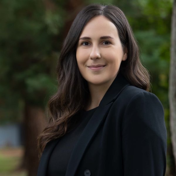 A professional woman wearing a black blazer over a black shirt | Estate Lawyer | Myatt & Bell, P.C.