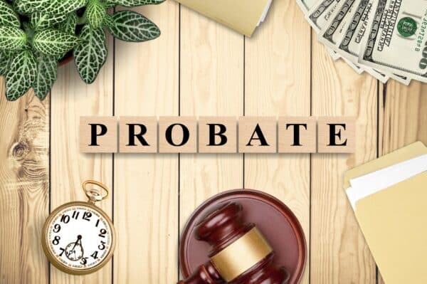 Probate written on wooden blocks. Surrounded by a plant, clock, gavel, folder and money