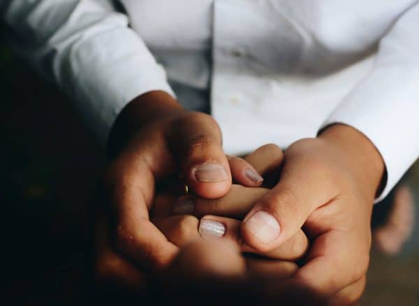 Man Holding Hand Of A Woman | Trust Administration Services | Myatt & Bell, P.C.