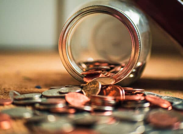 Coins Spilling From A Jar | Estate Lawyer | Myatt & Bell, P.C.
