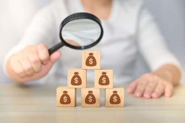 Magnifying Glass Over Dollars | Estate Planning | Myatt & Bell